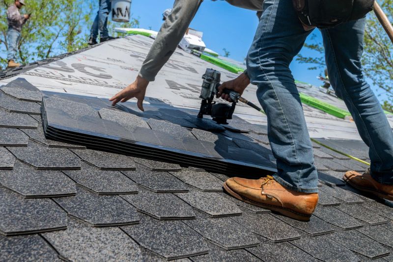 Roofing professional installing asphalt shingles on a Phoenix, AZ home